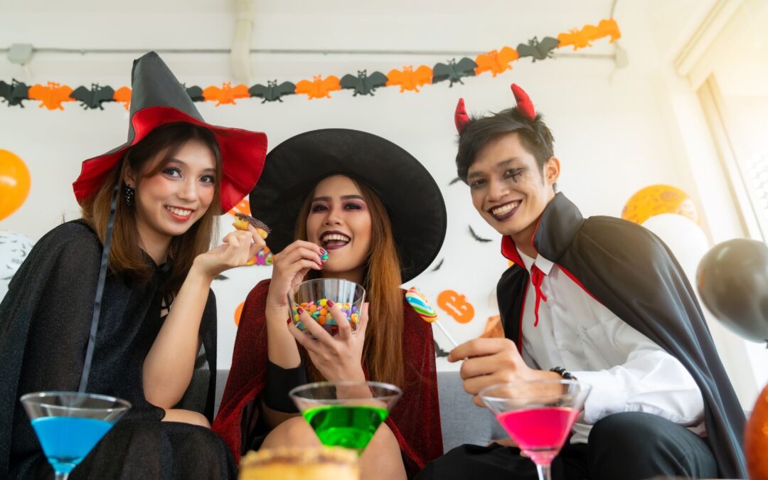 people dress up as witches and a vampire for a friendly halloween party