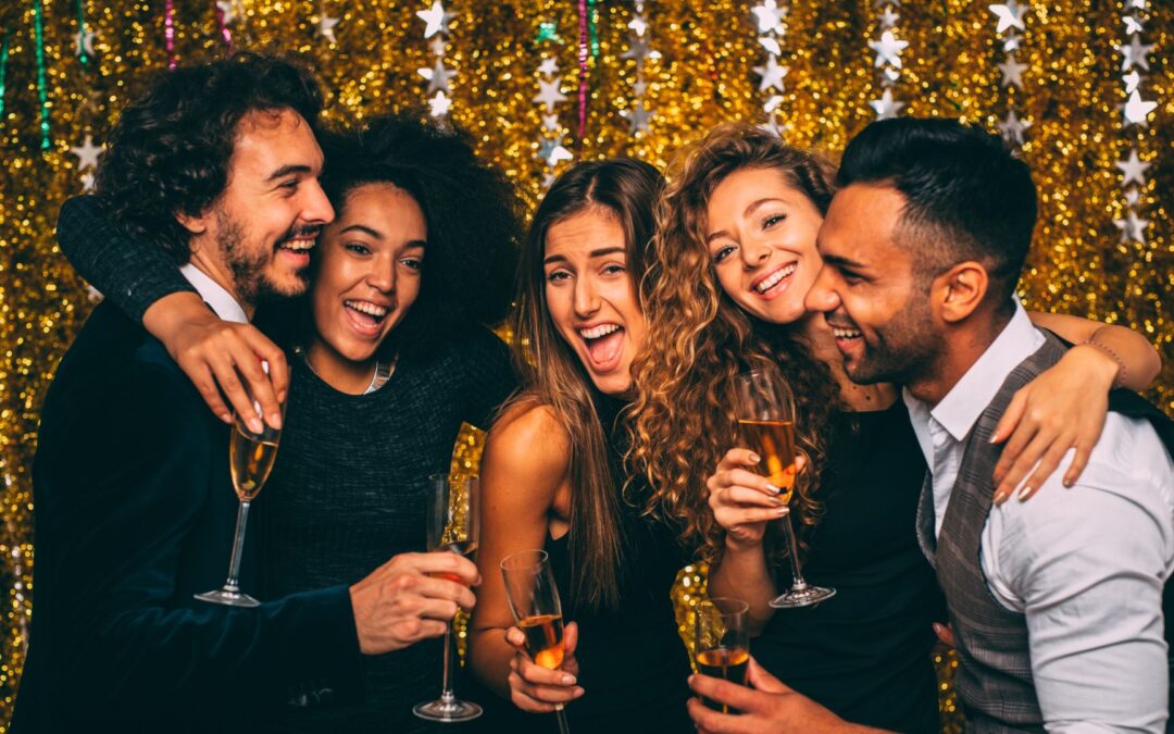 a group of partygoers smiling at the camera at a new years eve party