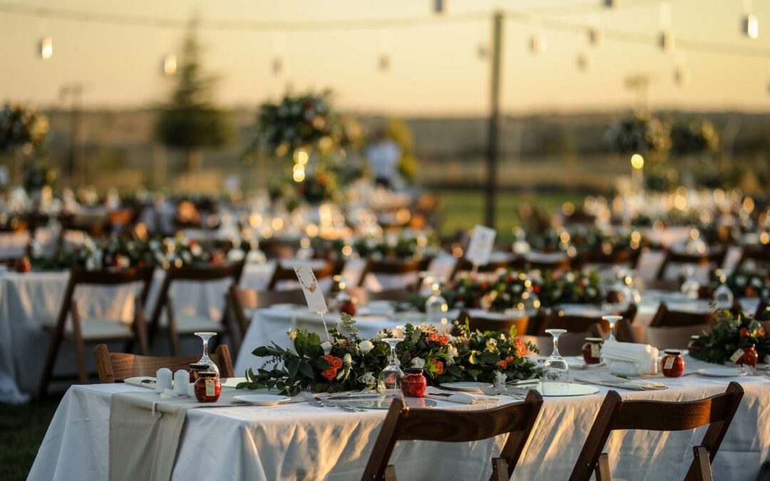 A gorgeous setup of outdoor dining tables at a wedding. Image demonstrates where you might serve your wedding menu.