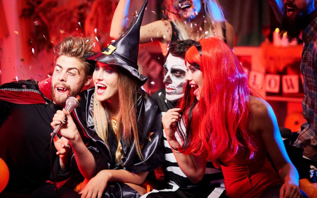 A group of friends who are dressed up for Halloween attend a Halloween party and pose for a fun photo together in their costumes.