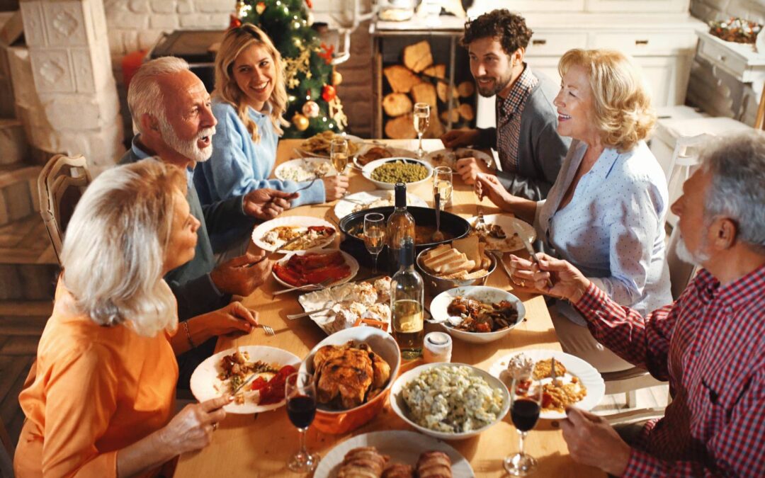 A family gathers around the dinner table and eats their Thanksgiving feast.